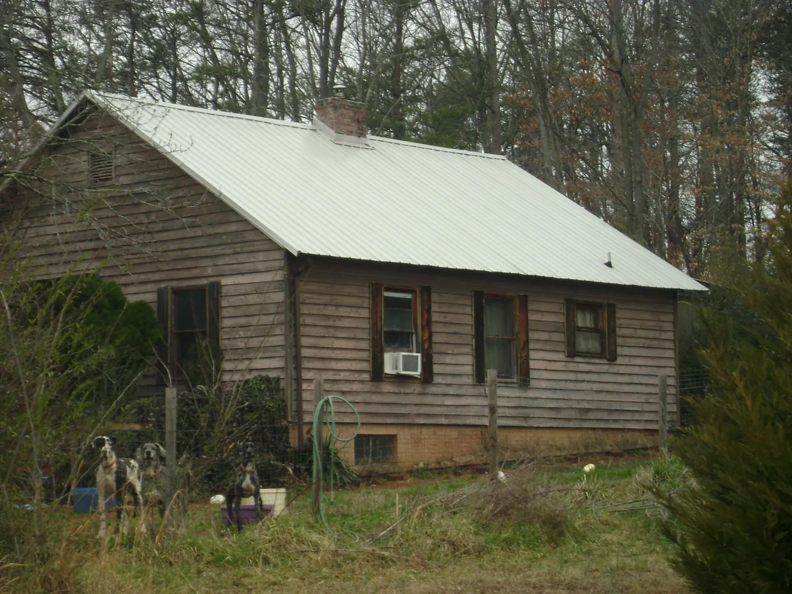 White metal roof on an old wood sided farmhouse, from a Asphalt Shingle Roof Repair job in Oakland Mills